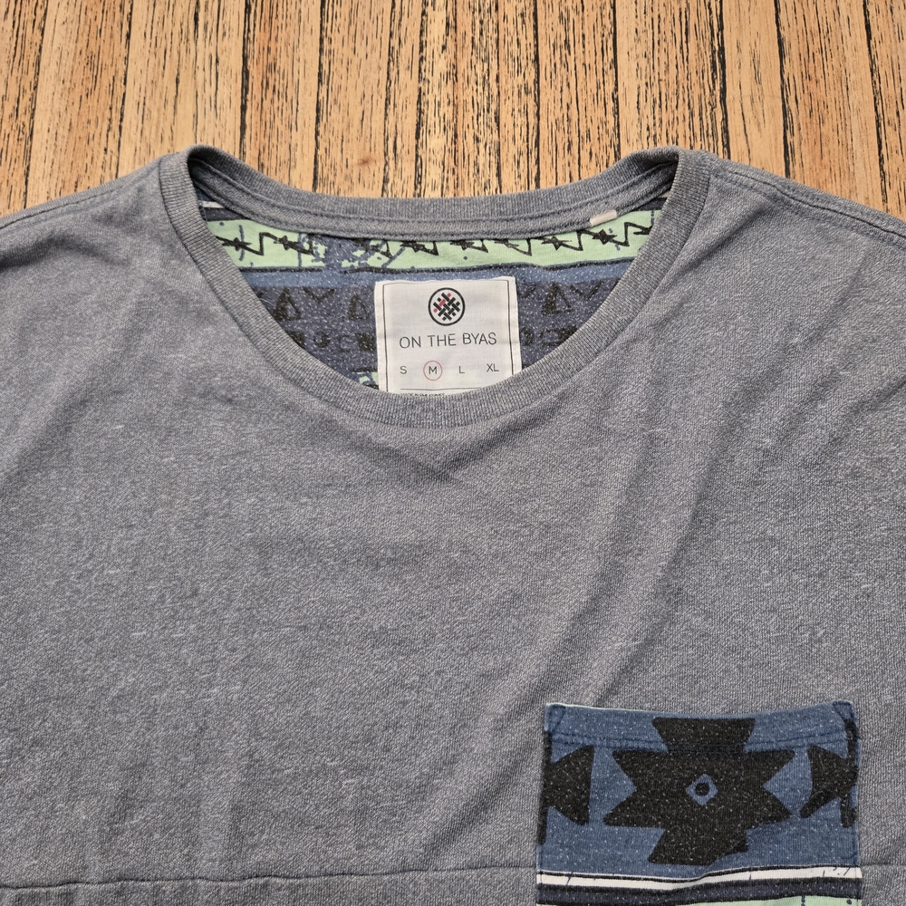 On The Byas T-shirt Mens Size Medium‎ Grey With Blue Design Pocket On Front.